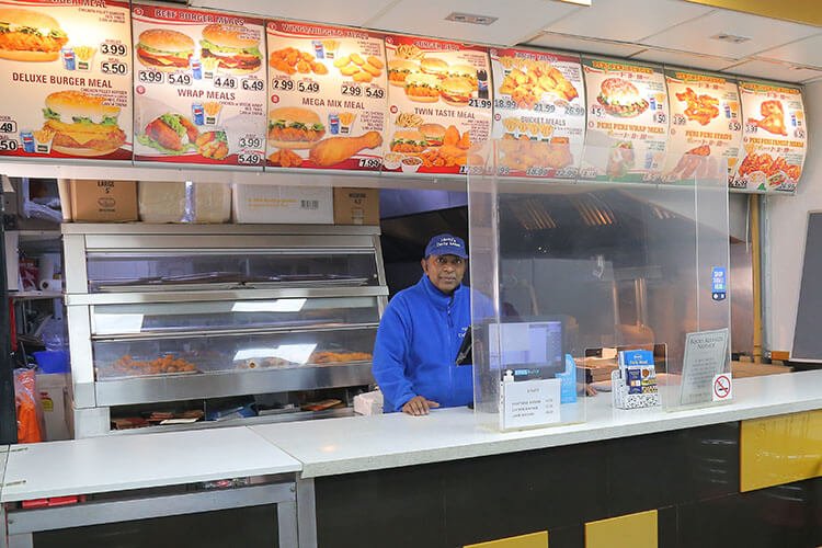 Cafe counter with a man standing behind the counter